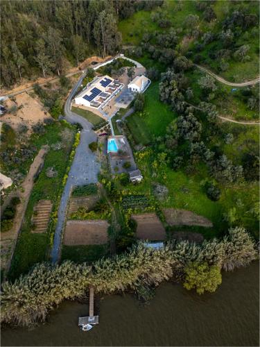 an aerial view of a house on the water at Apartamento para pareja, Finca Contrabando. Sanlucar del Guadiana in Sanlúcar de Guadiana