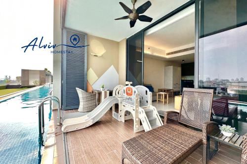 a balcony with a slide and a table and chairs at Alviv 99 Suites I Family Suite I 4-7 pax I 5minsMelakaCruise I JonkerSt in Melaka