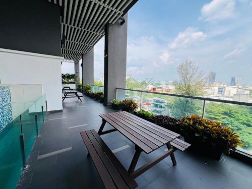 a balcony with a wooden bench on a building at VUE Residences Klcc view ,2 min to HKL,Chowkit Monorail & MRT & BUS in Kuala Lumpur
