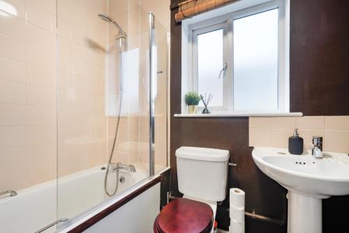 a bathroom with a toilet and a sink and a shower at Stylish 3 Bed in Central London - Garden in London
