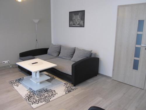 a living room with a couch and a table at Appartment Ipsum in Löbau