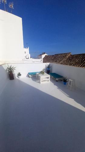 a white building with plants on the side of it at La Casa del Callejón in Vejer de la Frontera