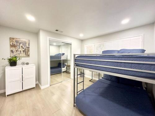 a room with two bunk beds and a mirror at Mins To Pasadena Charm & Rose Bowl in Altadena