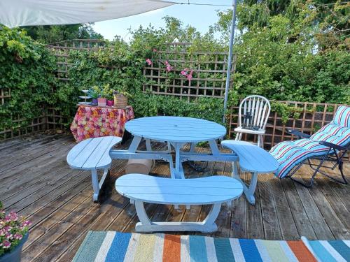 a blue picnic table and chairs on a deck at Big bright room in Carrigaline