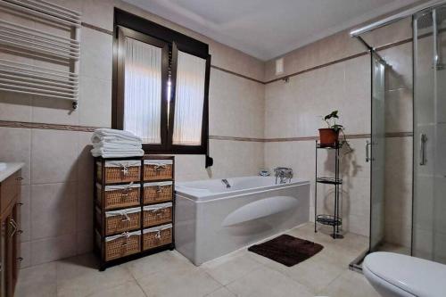 a bathroom with a tub and a shower and a sink at Chalet zona Los Gallos in Chiclana de la Frontera