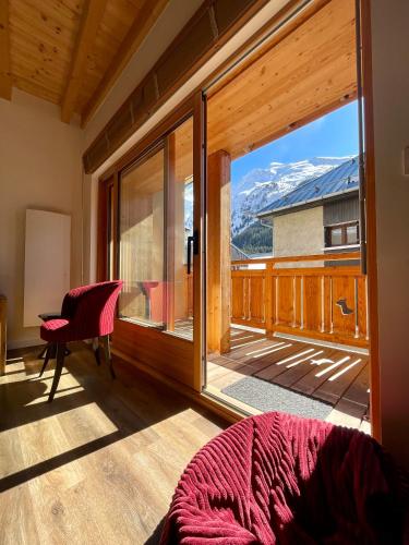 a room with a large window with a view at La MaiZon du Bois in Champagny-en-Vanoise