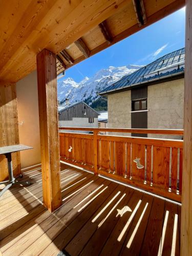 a deck with a view of a mountain at La MaiZon du Bois in Champagny-en-Vanoise