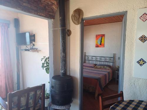 a room with a fireplace in a bedroom with a bed at Amanecer en aguas dulces in Aguas Dulces