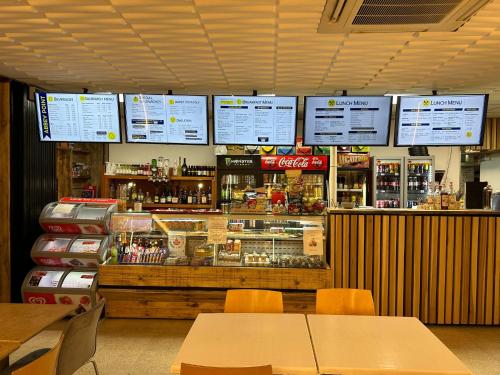 a fast food restaurant with a counter and tables at Abbey Point Hotel in London