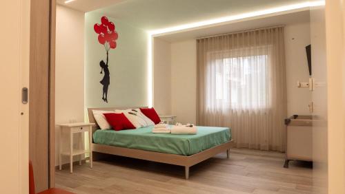 a bedroom with a bed with a balloon on the wall at Wanderlust Guesthouse in Gaeta