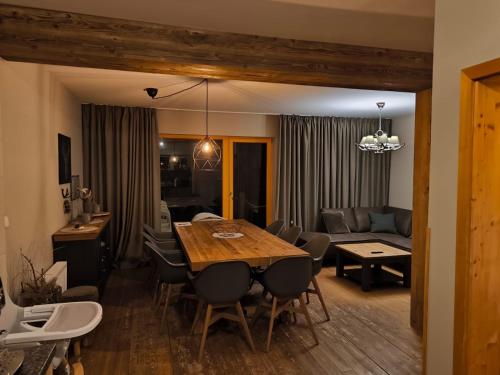 ein Esszimmer und ein Wohnzimmer mit einem Tisch und Stühlen in der Unterkunft Naturepark Resort in Harrachov