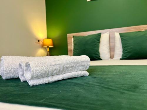 a bedroom with a bed with white towels on it at Byurakan Villas near Kari Lake in Byurakan