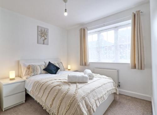 a bedroom with a bed and a window at Hythe Hill Home in Colchester