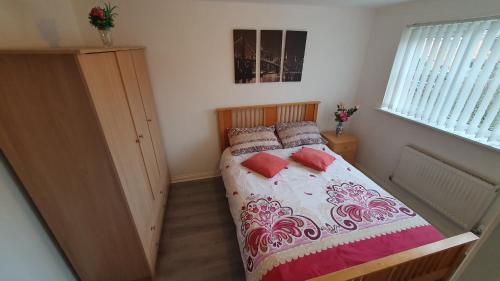 a small bedroom with a bed and a window at Lovely 3 Bedroom House in Greater Manchester in Manchester