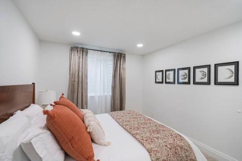 a white bedroom with a large bed with pillows at Spanish Fork Retreat in Spanish Fork