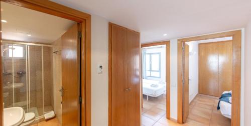 a bathroom with a sink and a shower and a toilet at Holiday beach homes Romaní II in Colònia de Sant Jordi