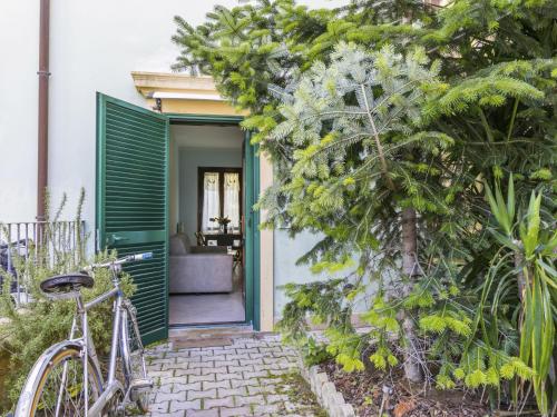 a bike parked in front of a house with a green door at Apartment Casa Fenix by Interhome in Cecina