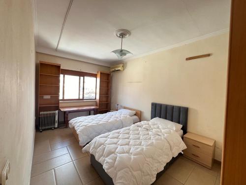 a bedroom with two beds and a window at Tirana Center 2Bedrooms in Tirana