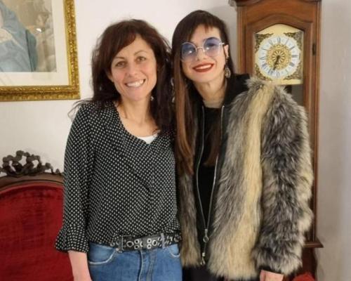 two women standing next to each other in front of a clock at Affittacamere San Teodoro in Albenga