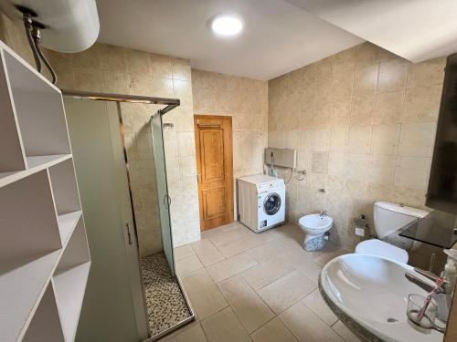 a bathroom with a shower and a toilet and a sink at Tirana Center 2Bedrooms in Tirana