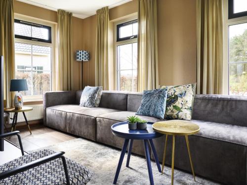 a living room with a couch and a table at Holiday Home Lieskehuis Wellness de Luxe 10-2 by Interhome in Vlagtwedde
