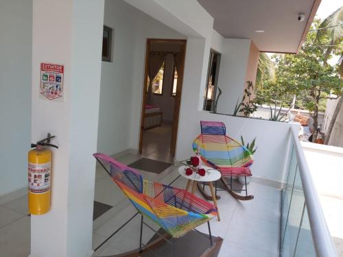 a balcony with a colorful chair and a table at Dreimar Hotel Boutique in Cartagena de Indias