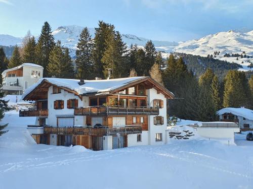 a house in the snow with snow covered at Apartment Ferienwohnung Montana-Staub by Interhome in Lenzerheide