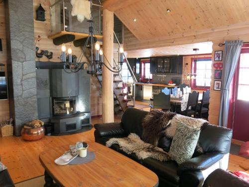 a living room with a leather couch and a table at Holiday Home Ørnefjell - SOW162 by Interhome in Åseral