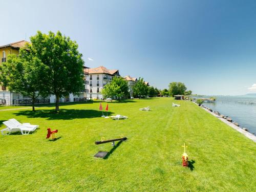 a large grassy field next to a body of water at Apartment Andreas by Interhome in Balatonőszöd