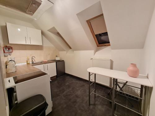 a small kitchen with a counter and a table at Ferienwohnung Warnitz in Blankenburg Oberuckersee