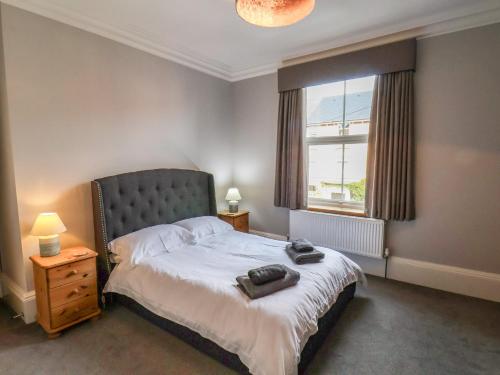 a bedroom with a large bed and a window at 11 Highfield in Scarborough