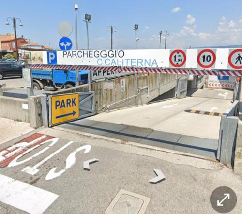 a gate in a street with a sign on it at CasamargheRita in Muggia