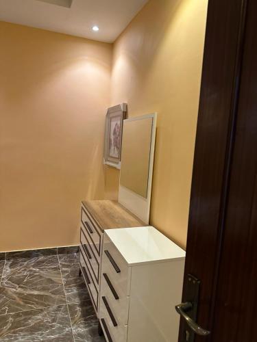 a bathroom with a vanity with a mirror and a dresser at شاليه قلب الهدا 3-4 in Al Hada