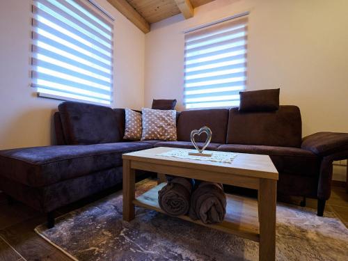 a living room with a couch and a coffee table at Chalet Pod lesem by Interhome in Smržovka