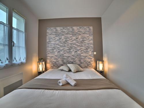 a bedroom with a large bed with two pillows at Holiday Home La Parie 1 by Interhome in Dolus d'Oléron