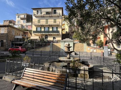 a park bench next to a fountain in a city at Apartment Marina by Interhome in Dolcedo