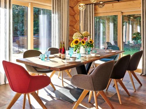 a dining room with a wooden table and chairs at Chalet Schwarzwaldchalet de luxe mit Sauna by Interhome in Heitersheim