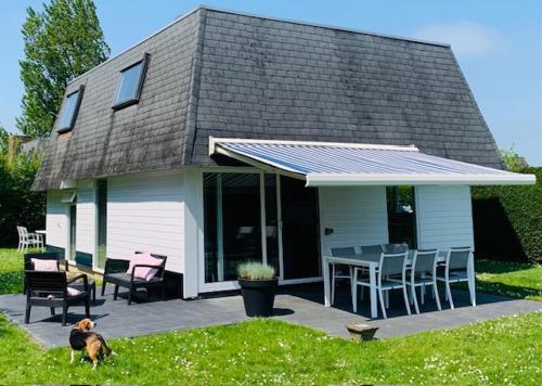 a house with a patio with a table and chairs at Park Schoneveld, Zeester 24 in Breskens
