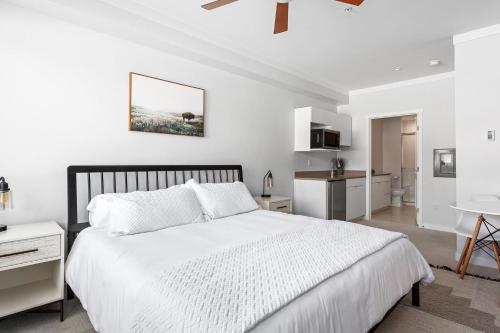 a white bedroom with a large bed and a bathroom at Perfect Peak, Unit 2B in Fraser