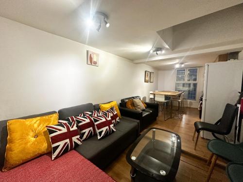 a living room with a couch and a table at Fernando flats in London