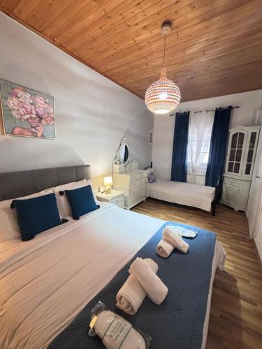 a bedroom with a large bed with towels on it at The Port House Sea Breeze in Agios Georgios