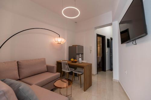 a living room with a couch and a table at Archangelos SKY Junior Apartment in Archangelos