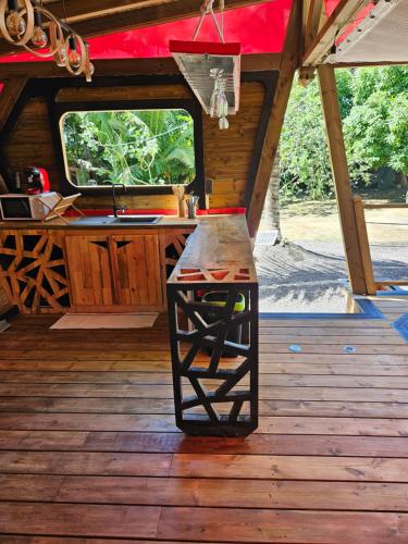 an inside view of a cabin with a counter on a wooden floor at Bungalow Ti Koko in Le Gosier