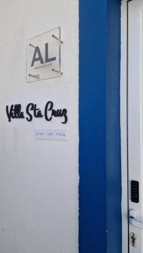 a sign for a vm sh club on a wall at Santa Cruz Villas in Santa Cruz das Flores