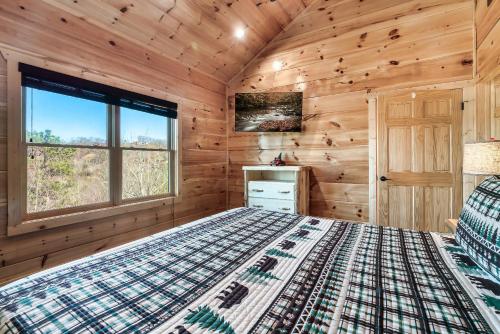 a bedroom with a bed in a log cabin at Full Equipped Cabin with a Pool and Game Room Smokies Views in Gatlinburg