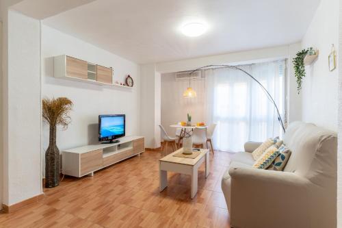 a living room with a couch and a tv at Trendy Homes Catedral in Almería