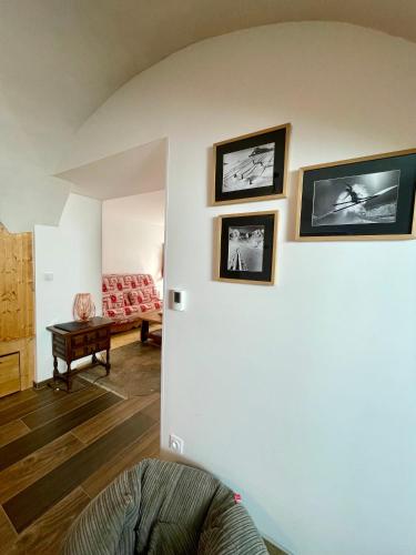 a living room with three pictures on the wall at La MaiZon du Bois in Champagny-en-Vanoise