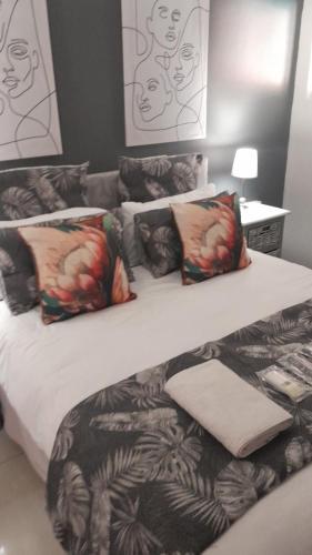 a bedroom with two twin beds with pillows at Robert's Place Paarl in Paarl