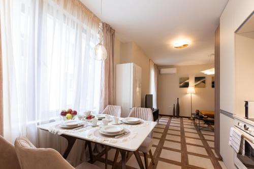 a dining room with a white table and chairs at Didi's Central Designer Apartments in Sofia