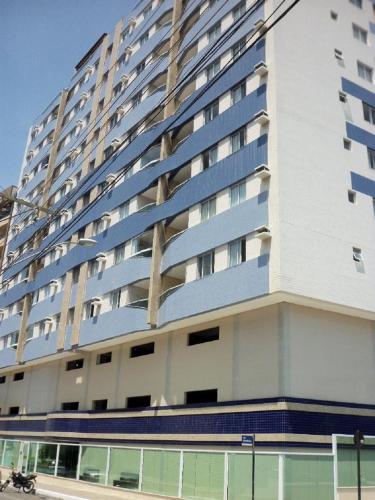 a large apartment building with blue balconies at Guarapari Praia - 2 quartos 1 banheiro ar condicionado in Guarapari